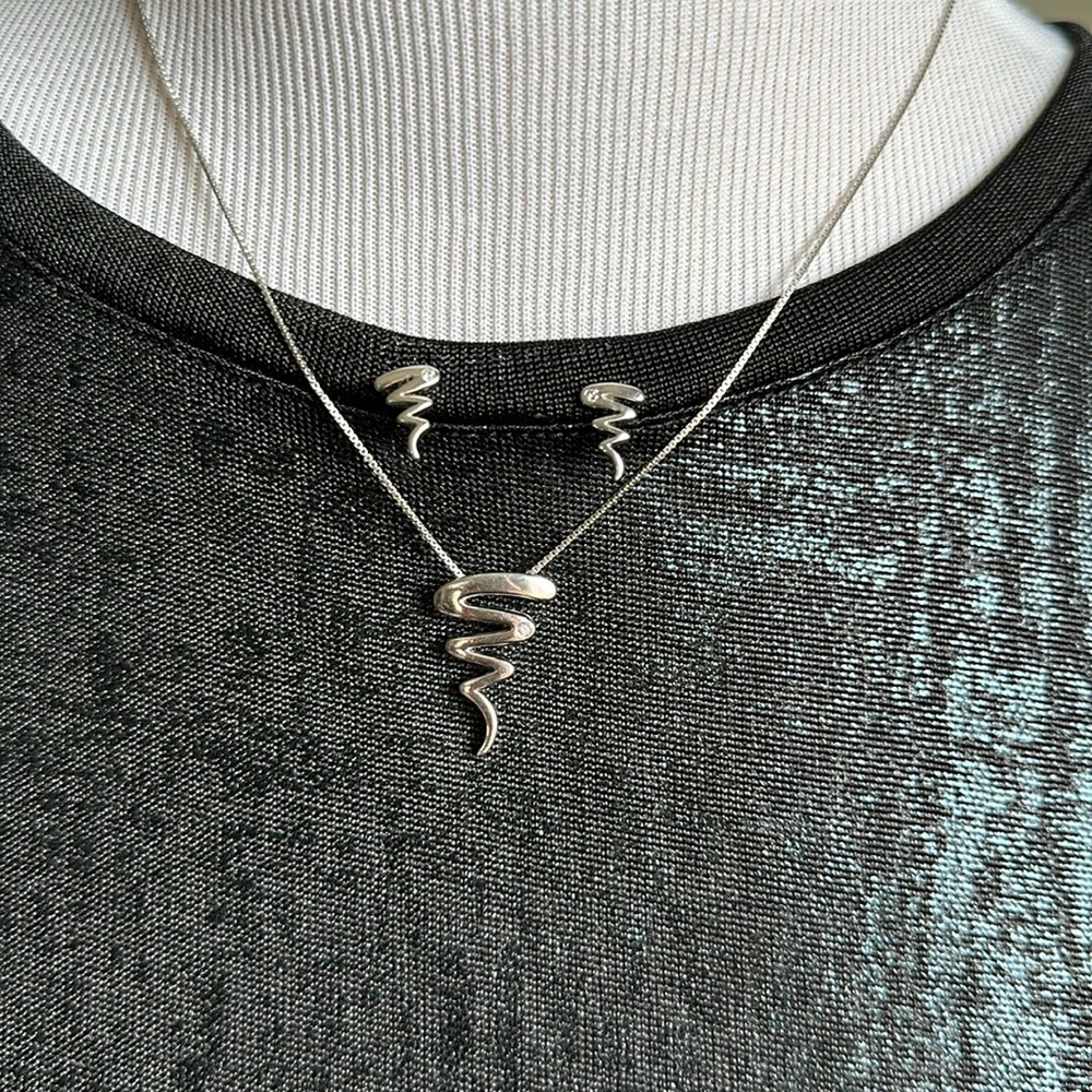 Matching sterling silver “tornado” necklace/earrings with diamond accent
